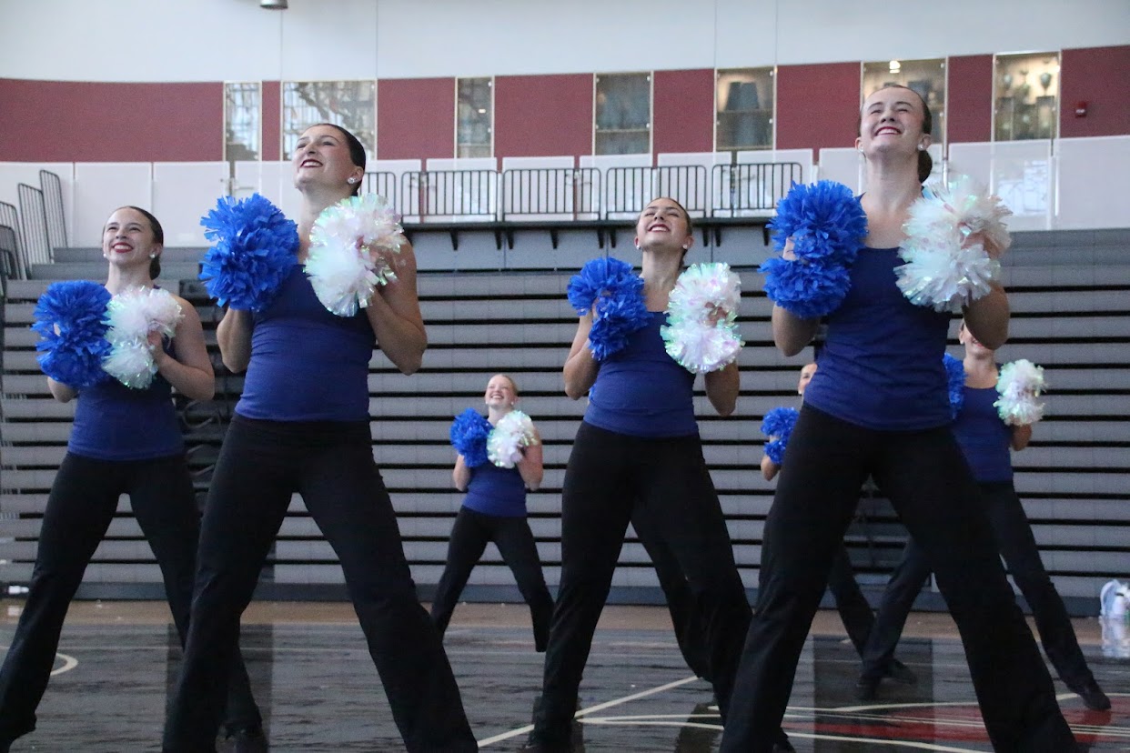 Cheerleaders Team in Uniform Dancing with Pompons and Making